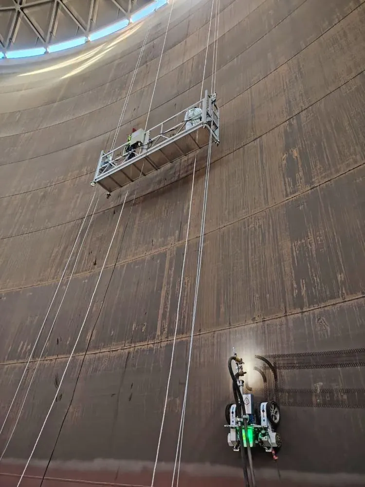 Inside a terminal tank — robot below, cradle above
